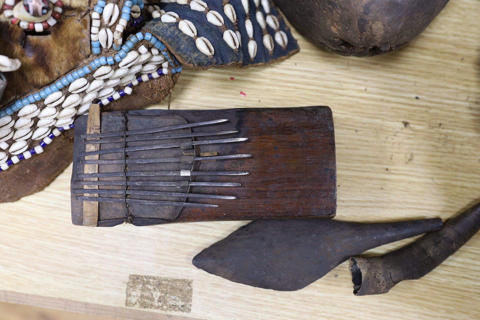 A group of Democratic Republic of Congo tribal carved wood figures and instrument and a Kuba style beadwork and shell mount mask